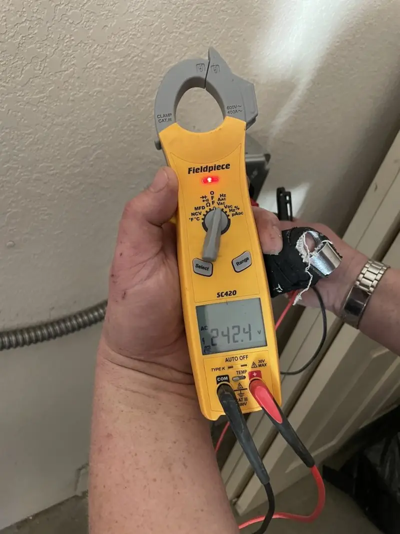 Voltage testing with clamp meter during Whole House Surge Protector in Elbridge